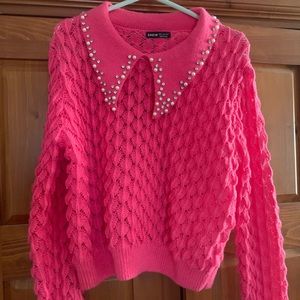 Woman’s pink sweater